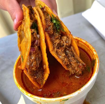 Two gourmet tacos close-up with fresh toppings