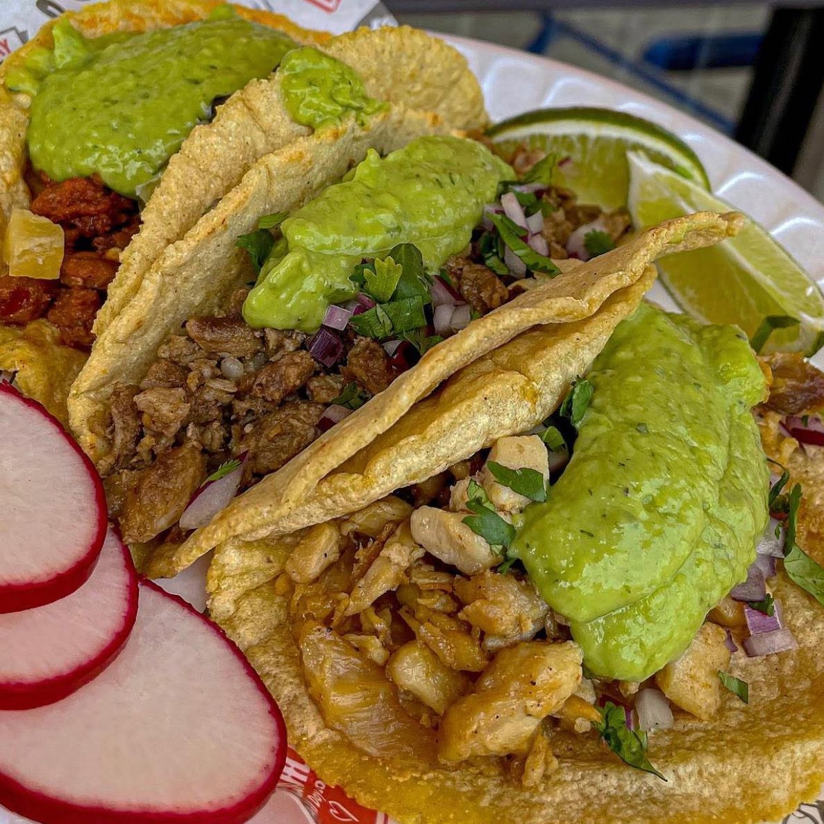 Fresh taco with lime being squeezed — Tacopolis birria tacos